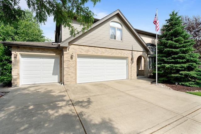17815 Iroquois, Tinley Park, IL 60477 - view of front of home with concrete driveway, brick siding, and an attached garage