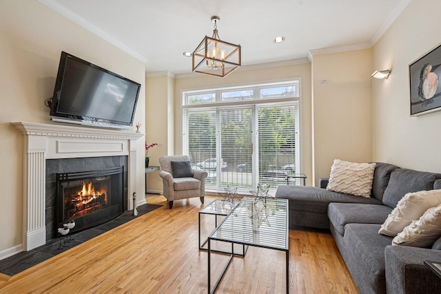1720 W Diversey Pkwy Unit 1, Chicago, IL 60614 - living area with a tiled fireplace, wood finished floors, crown molding, a chandelier, and recessed lighting