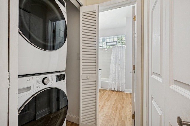 1720 W Diversey Pkwy Unit 1, Chicago, IL 60614 - washroom with estacked washer and dryer and light wood finished floors