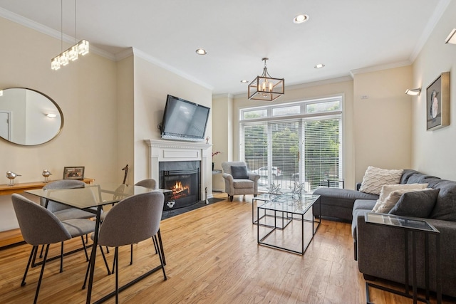 1720 W Diversey Pkwy Unit 1, Chicago, IL 60614 - living room with a fireplace with flush hearth, light wood finished floors, ornamental molding, a chandelier, and recessed lighting