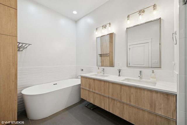 639 W Briar Pl Unit 4W, Chicago, IL 60657 - full bath with double vanity, tile walls, a freestanding tub, tile patterned floors, and wainscoting
