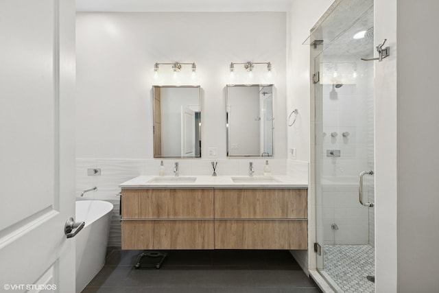 639 W Briar Pl Unit 4W, Chicago, IL 60657 - full bathroom with a stall shower, double vanity, a soaking tub, tile patterned floors, and tile walls