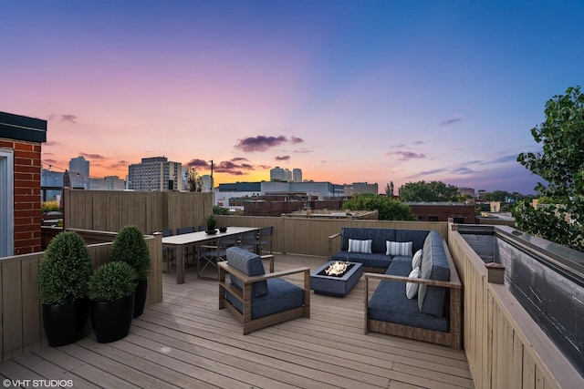 639 W Briar Pl Unit 4W, Chicago, IL 60657 - wooden deck featuring an outdoor living space with a fire pit, a city view, and outdoor dining area
