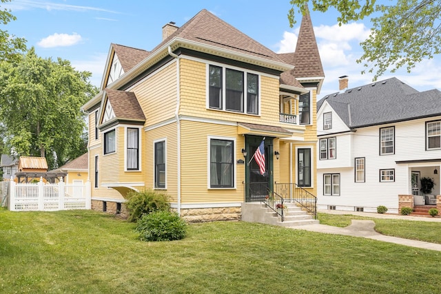 557 Garfield Ave, Aurora, IL 60506 - victorian house featuring roof with shingles and a chimney
