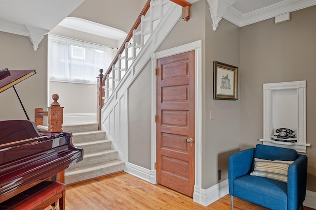 557 Garfield Ave, Aurora, IL 60506 - entryway with stairway, light wood-style floors, and crown molding