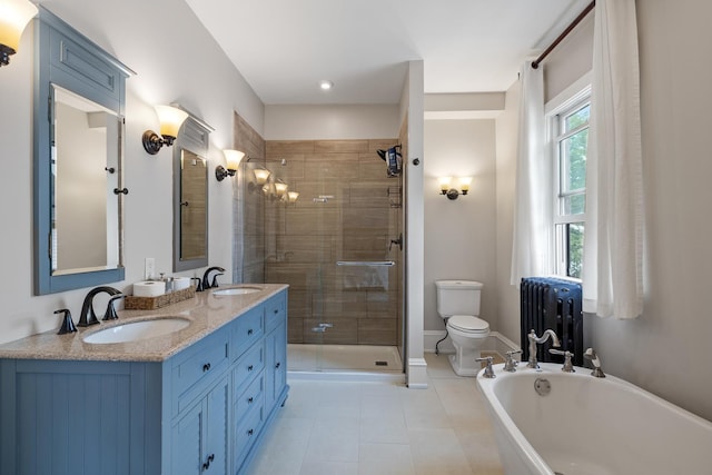 557 Garfield Ave, Aurora, IL 60506 - full bath featuring radiator, a soaking tub, double vanity, a shower stall, and tile patterned flooring