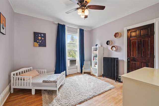 557 Garfield Ave, Aurora, IL 60506 - bedroom featuring radiator, light wood-style flooring, crown molding, and ceiling fan