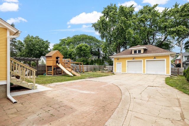 557 Garfield Ave, Aurora, IL 60506 - view of yard featuring a playground and a garage