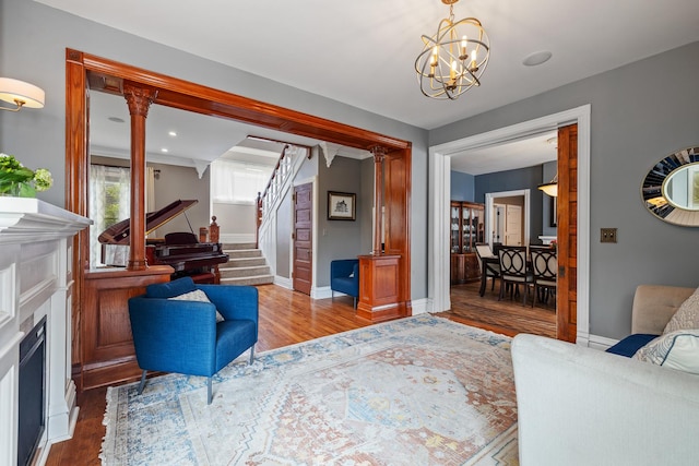 557 Garfield Ave, Aurora, IL 60506 - living area featuring wood finished floors, stairs, a chandelier, and a fireplace