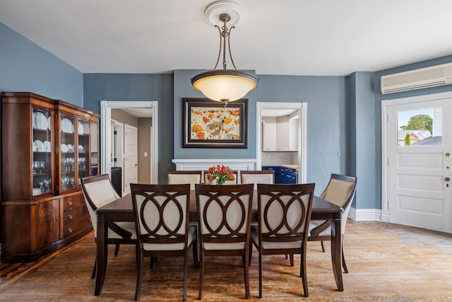 557 Garfield Ave, Aurora, IL 60506 - dining space with a wall mounted air conditioner and wood finished floors