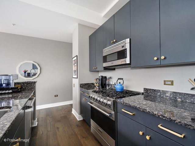 500 W Superior St Unit 1202, Chicago, IL 60654 - kitchen featuring appliances with stainless steel finishes, dark wood-type flooring, and dark stone counters