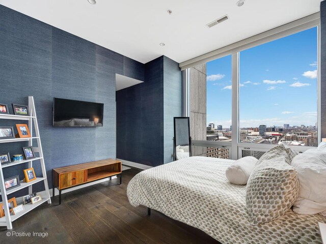 500 W Superior St Unit 1202, Chicago, IL 60654 - bedroom featuring wood-type flooring, wallpapered walls, multiple windows, floor to ceiling windows, and a city view