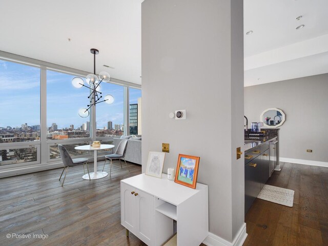 500 W Superior St Unit 1202, Chicago, IL 60654 - dining space with dark wood-type flooring, a view of skyline, a chandelier, and floor to ceiling windows
