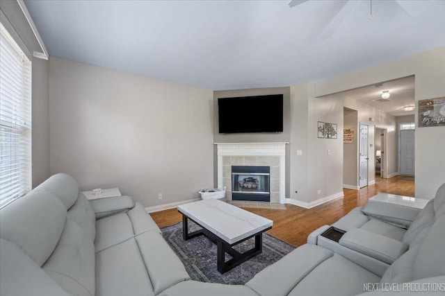 725 Bohannon Cir, Oswego, IL 60543 - living area featuring wood finished floors, a ceiling fan, and a tile fireplace