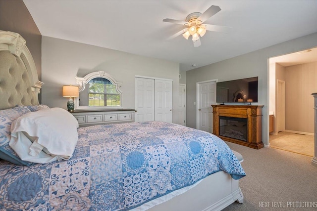 725 Bohannon Cir, Oswego, IL 60543 - bedroom featuring a glass covered fireplace, carpet flooring, ceiling fan, and a closet