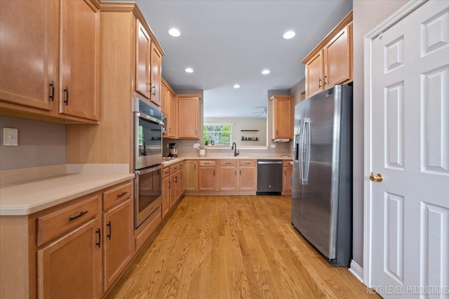 725 Bohannon Cir, Oswego, IL 60543 - kitchen with appliances with stainless steel finishes, light wood-style floors, light countertops, recessed lighting, and light brown cabinetry