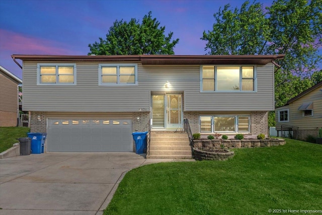 8826 Willow Rd, Hickory Hills, IL 60457 - raised ranch featuring brick siding, a front lawn, and a garage
