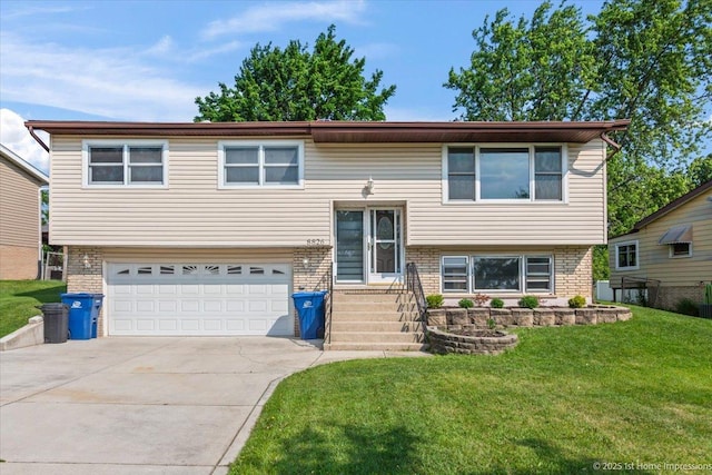 8826 Willow Rd, Hickory Hills, IL 60457 - bi-level home featuring brick siding, a front lawn, driveway, and an attached garage