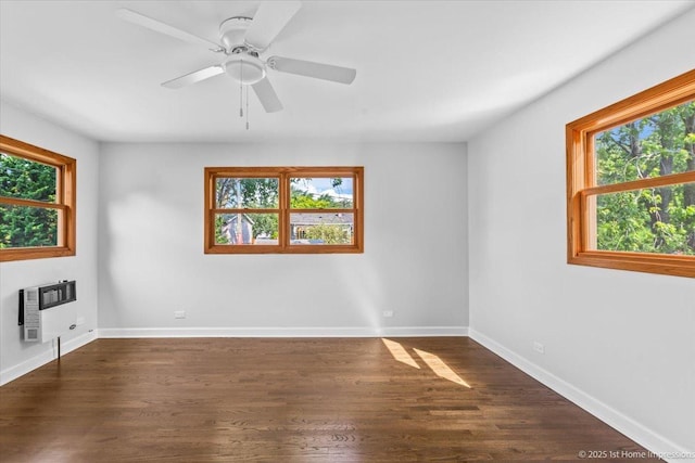 8826 Willow Rd, Hickory Hills, IL 60457 - spare room featuring heating unit, plenty of natural light, dark wood-style floors, and ceiling fan