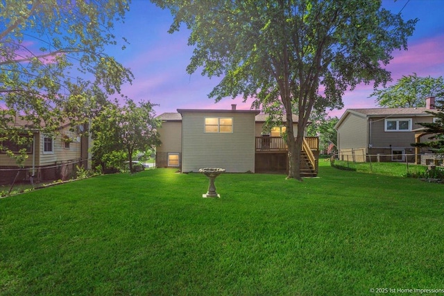 8826 Willow Rd, Hickory Hills, IL 60457 - back of house at dusk featuring stairs, a fenced backyard, and a deck