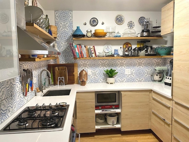 559 W Surf St Unit 101, Chicago, IL 60657 - kitchen with open shelves, appliances with stainless steel finishes, and light countertops