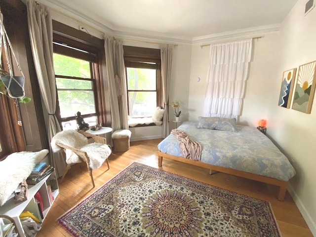 559 W Surf St Unit 101, Chicago, IL 60657 - bedroom featuring wood finished floors and ornamental molding