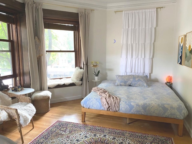 559 W Surf St Unit 101, Chicago, IL 60657 - bedroom with multiple windows, wood finished floors, and ornamental molding
