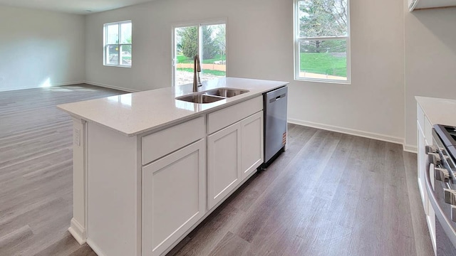 11300 Wildridge Ln, Huntley, IL 60142 - kitchen with dishwasher, stove, light wood-style flooring, light countertops, and a center island with sink