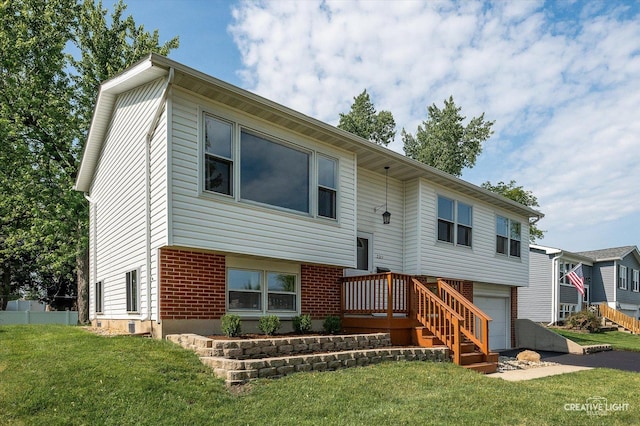 2211 Birchwood Pkwy, Woodridge, IL 60517 - back of house featuring a lawn, an attached garage, and brick siding