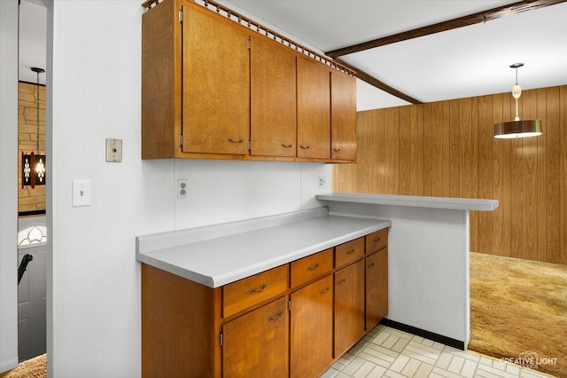 2211 Birchwood Pkwy, Woodridge, IL 60517 - kitchen featuring light countertops, brown cabinets, and hanging light fixtures