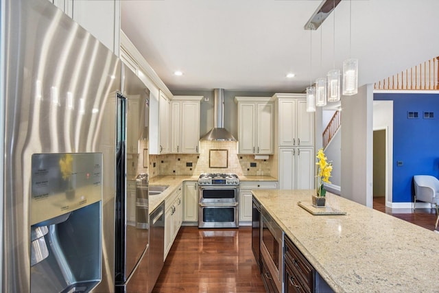 765 Providence Ln, Crystal Lake, IL 60012 - kitchen featuring appliances with stainless steel finishes, wall chimney exhaust hood, light stone countertops, dark wood-style floors, and decorative light fixtures