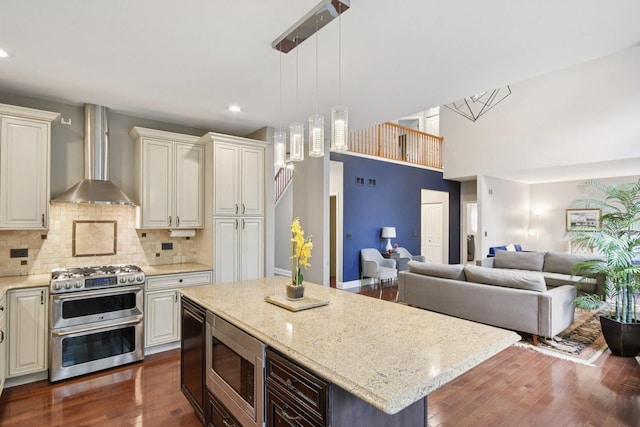 765 Providence Ln, Crystal Lake, IL 60012 - kitchen with stainless steel appliances, wall chimney exhaust hood, light stone counters, dark wood finished floors, and recessed lighting