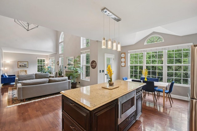765 Providence Ln, Crystal Lake, IL 60012 - kitchen featuring stainless steel appliances, dark wood-style floors, lofted ceiling, decorative light fixtures, and dark brown cabinetry