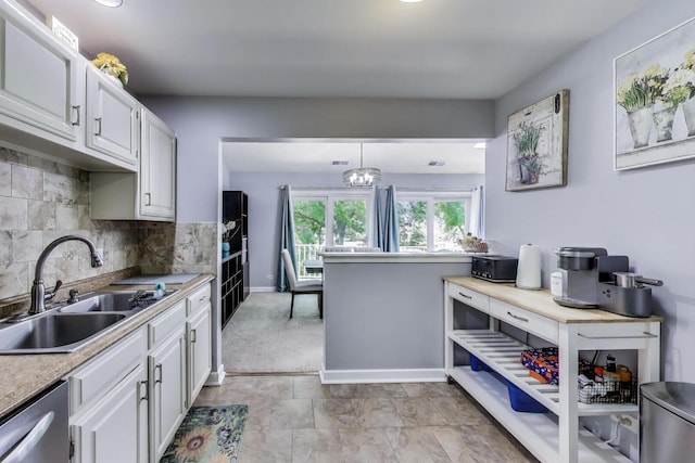 2406 Mallow Ct Unit V2, Schaumburg, IL 60194 - kitchen featuring white cabinets, stainless steel dishwasher, light countertops, and tasteful backsplash
