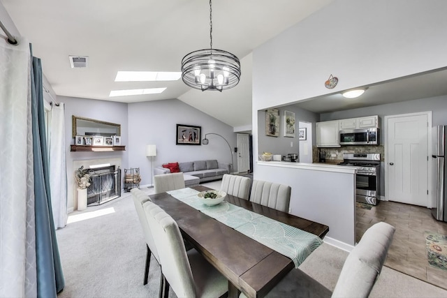 2406 Mallow Ct Unit V2, Schaumburg, IL 60194 - dining room with a skylight, lofted ceiling, dark colored carpet, a glass covered fireplace, and a chandelier