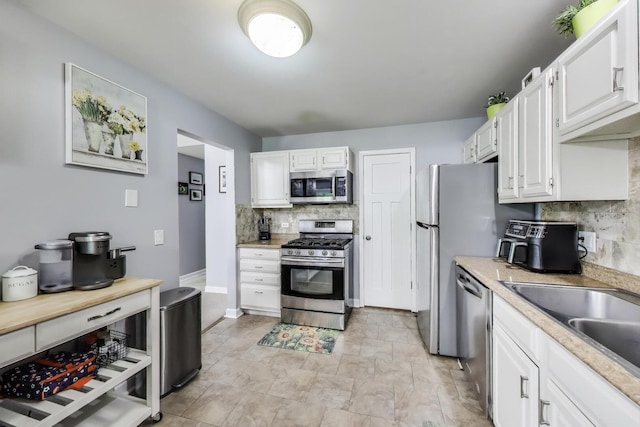 2406 Mallow Ct Unit V2, Schaumburg, IL 60194 - kitchen featuring stainless steel appliances, tasteful backsplash, light countertops, and white cabinets