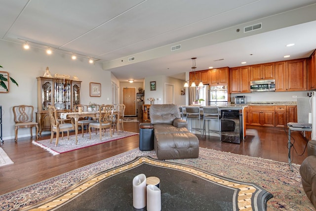 1199 E Port Clinton Rd Unit 209, Vernon Hills, IL 60061 - living area with dark wood-style flooring, rail lighting, and a chandelier