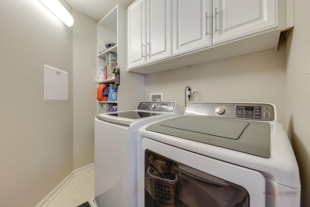 1199 E Port Clinton Rd Unit 209, Vernon Hills, IL 60061 - laundry area with washing machine and clothes dryer, cabinet space, and light tile patterned floors