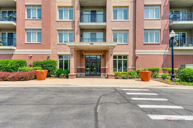 1199 E Port Clinton Rd Unit 209, Vernon Hills, IL 60061 - view of apartment building / complex featuring uncovered parking
