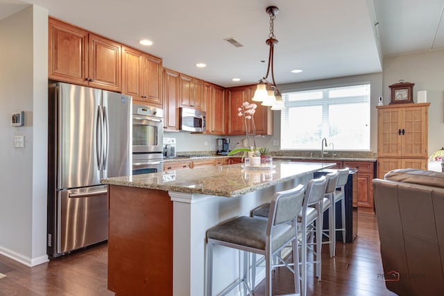 1199 E Port Clinton Rd Unit 209, Vernon Hills, IL 60061 - kitchen with stainless steel appliances, dark wood-style floors, light stone counters, a center island, and recessed lighting