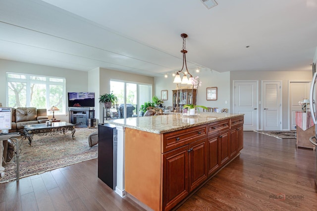 1199 E Port Clinton Rd Unit 209, Vernon Hills, IL 60061 - kitchen with dark wood-style flooring, light stone counters, open floor plan, hanging light fixtures, and a chandelier