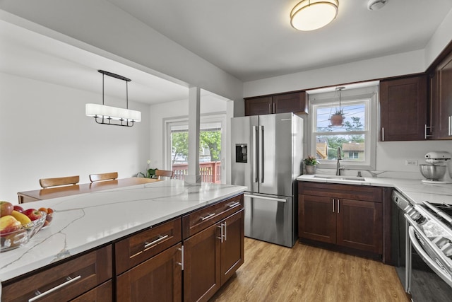 16401 Clark Ln, Tinley Park, IL 60477 - kitchen with appliances with stainless steel finishes, light wood finished floors, decorative light fixtures, and light stone countertops
