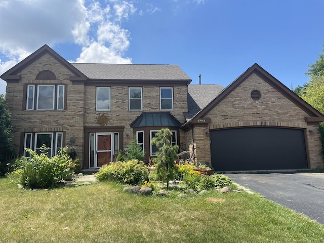 1724 Hartford Ln, Crystal Lake, IL 60014 - view of front facade featuring asphalt driveway, a front yard, brick siding, an attached garage, and a shingled roof