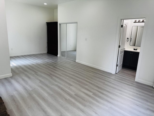 616 N Everett St, Streator, IL 61364 - unfurnished bedroom featuring light wood-type flooring, a closet, and ensuite bathroom