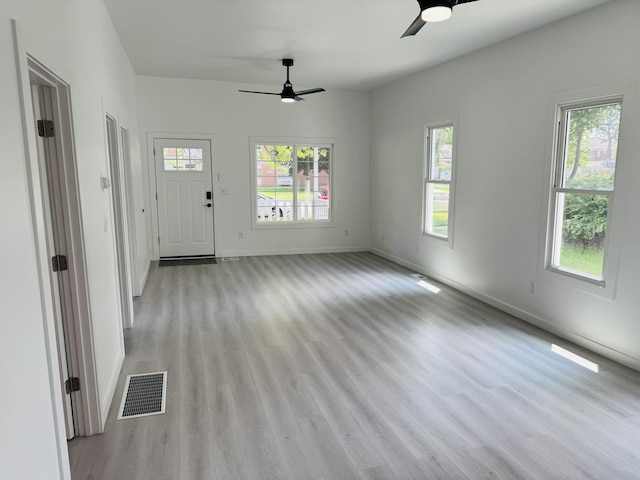 616 N Everett St, Streator, IL 61364 - unfurnished living room featuring ceiling fan, plenty of natural light, and wood finished floors