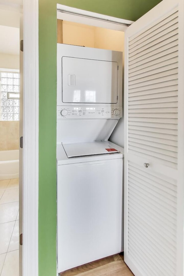 4333 N Troy St Unit 3E, Chicago, IL 60618 - laundry room featuring stacked washer / dryer and light tile patterned flooring