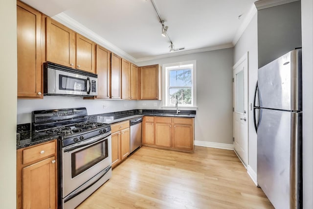 4333 N Troy St Unit 3E, Chicago, IL 60618 - kitchen with appliances with stainless steel finishes, light wood-style floors, track lighting, dark stone counters, and ornamental molding