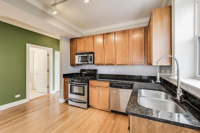 4333 N Troy St Unit 3E, Chicago, IL 60618 - kitchen with stainless steel appliances, ornamental molding, light wood-style floors, track lighting, and dark stone countertops