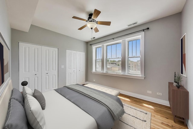 4333 N Troy St Unit 3E, Chicago, IL 60618 - bedroom with two closets, light wood finished floors, and ceiling fan