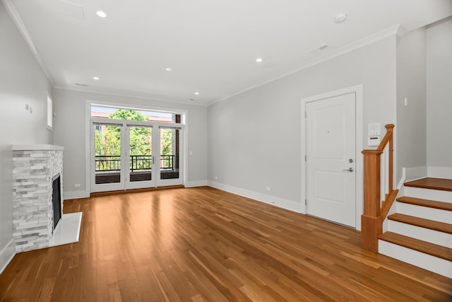 4133 N Kenmore Ave Unit 2S, Chicago, IL 60613 - unfurnished living room with wood finished floors, ornamental molding, a stone fireplace, recessed lighting, and stairway